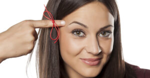 woman pointing finger at her temple to indicate memorization