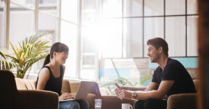 adults having a conversation around a table in a work environment
