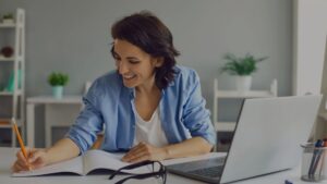 a woman smiling while taking notes