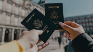 people holding up two passports